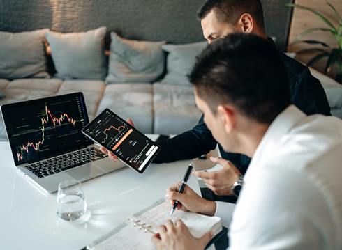 Traders analyzing graphs - Photo by AlphaTradeZone on Pexels