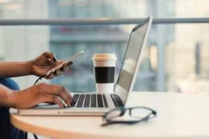 Discover the Best Non-UK Casinos for UK Casino Players Laptop with phone - Image by Christina Morillo on Pexels