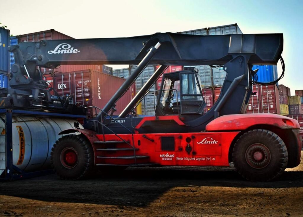 Trade front loader beside intermodal containers - Photo by Chanaka on Pexels