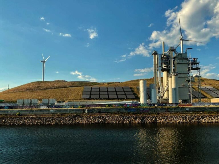 Solar panels with wind turbines - Photo by orlando s. on Pexels
