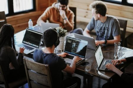 Office workers with laptops - Image by Annie Spratt on Unsplash